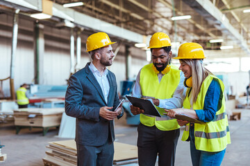 Team of Builders and Manager Discussing Project in Construction Warehouse