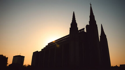 A massive brutalist cathedral built of concrete and glass, casting long shadows in the sunset, blending religious solemnity with futuristic geometry. created by generative ai