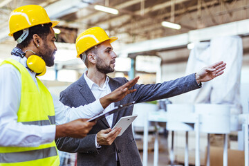 Colleagues Collaborating in an Industrial Workspace Wearing Safety Gear