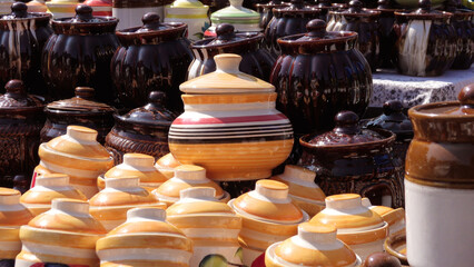 Colorful ceramic crockery items displayed in a street shop