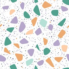Colorful terrazzo pattern with irregular shapes and dots on a white background, featuring green, orange, and purple tones.