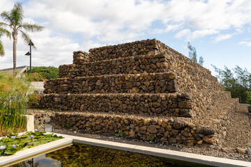 Stepped Stone Pyramid at the Pyramids of Güímar Surrounded by Vegetation and a Pond