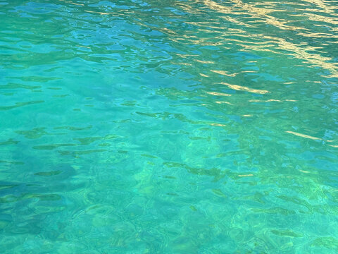 Sea clear blue green calm water surface.