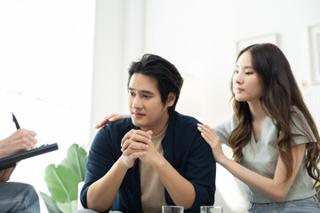 Asian man dealing with career failure receiving comfort from partner during counseling, highlighting impact of workplace pressure, mental exhaustion, therapy for emotional strength and recovery
