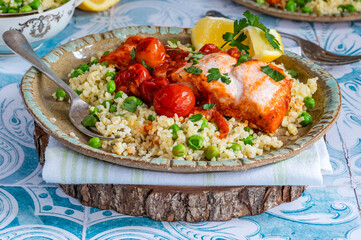 Harissa salmon with bulgur wheat, cherry tomatoes and green peas