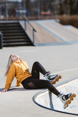 Young Woman in Yellow Hoodie Posing at Skate Park, Embracing Everyday Outdoor Activity and Urban Lifestyle
