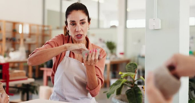 Woman, teaching and molding clay for pottery with sculpture design, learning technique and art process. People, potter and instructions for craft production, shape demonstration and creative workshop