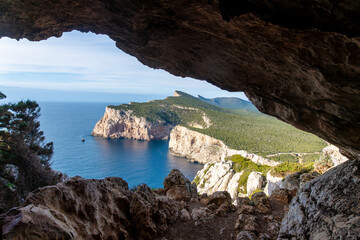 Coastal cliff and sea view from rocky cave at Capo Caccia