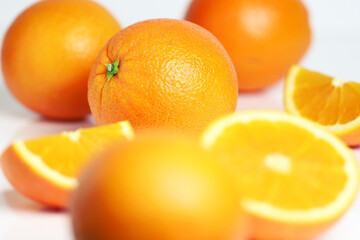 Oranges whole and sliced on white background