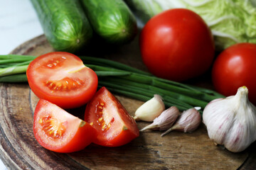 Set of fresh vegetables. Tomatoes, cucumbers, garlic, salad ingredients.
