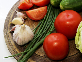Set of fresh vegetables. Tomatoes, cucumbers, garlic, salad ingredients.
