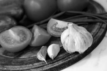 Garlic and other vegetables for cooking, black and white image.