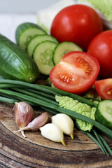 Set of fresh vegetables. Tomatoes, cucumbers, garlic, salad ingredients.
