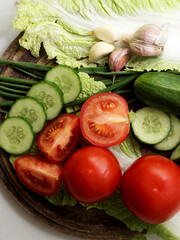 Set of fresh vegetables. Tomatoes, cucumbers, garlic, salad ingredients.
