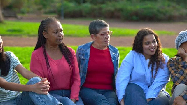 Crowd of multiracial people having fun together at city park - Social gathering, multi generational group and community concept