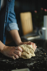 Cooking homemade pizza. Female hands making dough, adding sauce and ingredients.