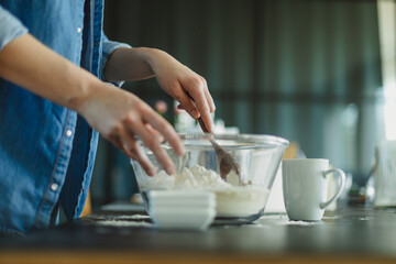 Cooking homemade pizza. Female hands making dough, adding sauce and ingredients.