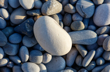 A white rock is sitting on a pile of rocks