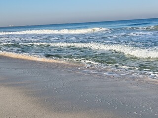 Water waves Sea Shore Beautiful Panorama white sand beach and turquoise water View.
Holiday summer beach background, Wave of sea on White sandy beach. Enjoy Holiday on Public Beach Heavy Water Waves