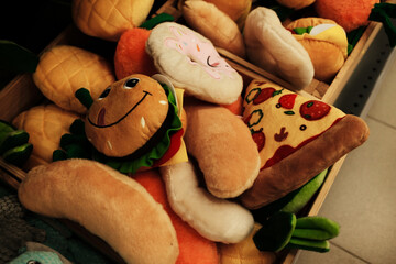 Plush dog toys shaped like funny food items including pizza, hamburger, donut, and hot dog. Soft and colorful ideal for playful pets and perfect for promoting pet products or accessories.