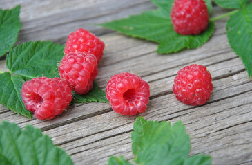 fresh ripe red raspberries on a wooden table