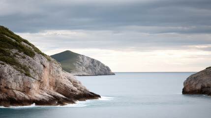 coastal cliff in albania under dramatic overcast sky showcasing natural symmetry