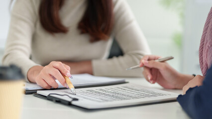 Muslim Business Agreement Asian Women Reviewing Contract with Pen in Office for Finance Legal Islamic Banking Solutions and Partnership Opportunities