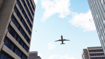 Obraz premium An airplane flew over the city between the buildings. Airplane flying over buildings in city, low angle view. Skyscraper airplane. Success business concept. 