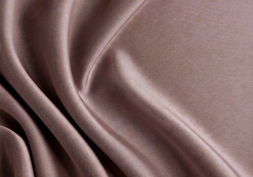 A close-up of softly draped light mauve fabric, possibly charmeuse, taffeta, or a charmeuse lining, showcasing its subtle sheen and flowing folds.