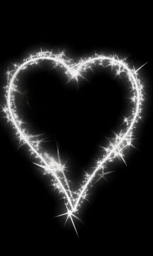 Animated sparkling heart outline in glowing white on black, vertical video format