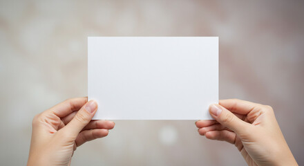 Hands presenting a blank white rectangular paper.
