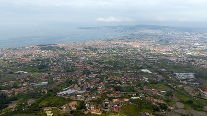 Aerial view of the metropolitan area of ​​Naples, Campania, Italy. In the background is the Gulf of Naples on the Mediterranean Sea.