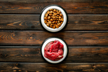 Various pet food in feeding bowls. Natural and dry food for choice. Top view
