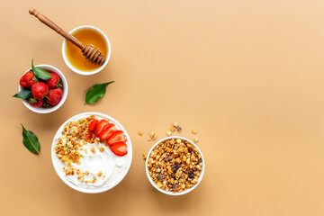 Flat lay composition with yogurt and muesli in bowl served with ingredients. Top view