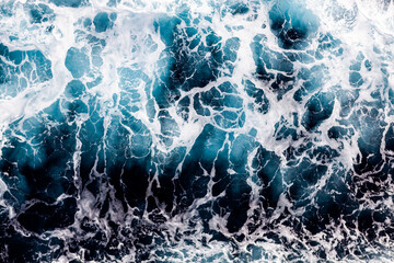 Ocean surface texture. Top view of captivating water with foam. Can be used in covers, packaging, posters, textures, brochures, art and design projects. Stylish nature background image.