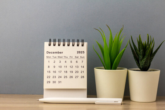 Hello, December 2025. Desktop calendar for planning on a gray background.