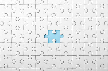 White Puzzle with Single Missing Piece Revealing blue Background