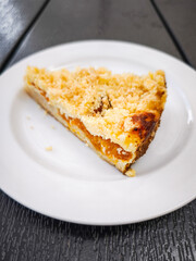Delicious slice of crumbly apricot fruit pie on a white plate showcasing a delightful dessert concept. copy space