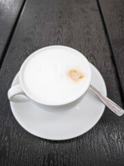 Creamy coffee cup Cappuccino with frothy milk on a saucer showcasing a delightful beverage concept. copy space