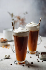 Iced coffee in a tall glasses with cream poured over