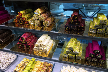 Various delicious Turkish delight in sweet shop window.