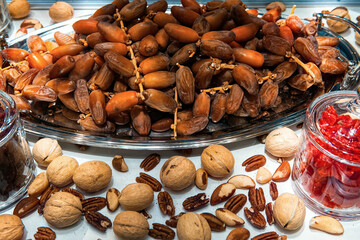Various nuts and dried fruits in health food store display case.