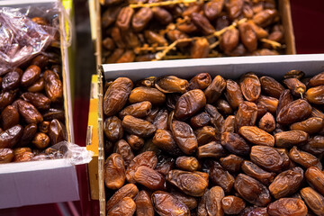 Selected dried dates in boxes at the market, top view. Natural oriental sweets.