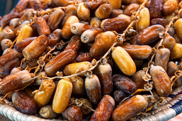 Close-up of selected dried dates on plate. Natural oriental sweets.