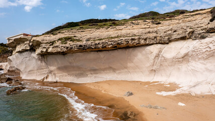 Eroded Coastal Cliffs and Sandy Beach in Portu Maga