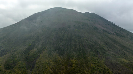 Fototapeta premium Aerial view of the summit of the Vesuvius volcano, in Campania, Italy. It is an active stratovolcano in a quiescent state. It's a rainy and cloudy day.