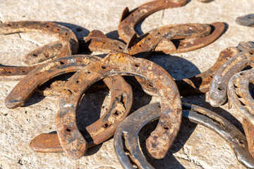 Rusty Horseshoes Scattered on Stone Surface