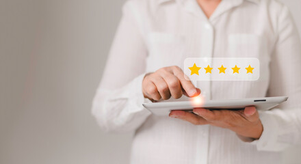  Customer service experience and business satisfaction survey woman using digital computer tablet with icon five star  for feedback review satisfaction service.