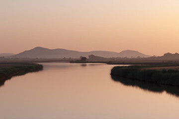 Fototapeta premium serene salt lake in tunisia during soft twilight surrounded by gentle natural curves