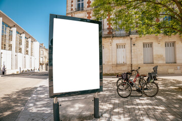 Blank billboard beside bicycles on city street - mockup